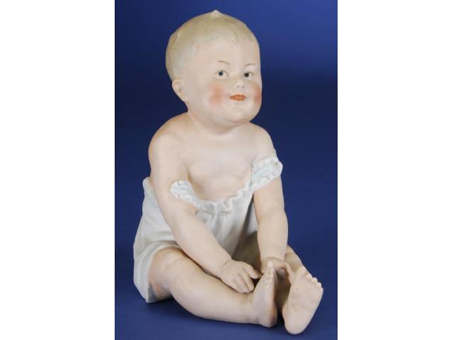 Appraisal: Large Heubach Seated Piano Baby Germany ca bisque seated figurine