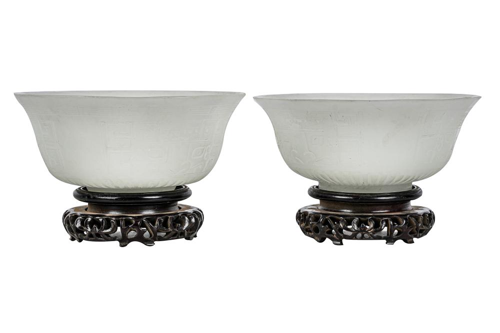 Appraisal: PAIR OF CHINESE GLASS BOWLS ON WOOD BASESPeking style glass