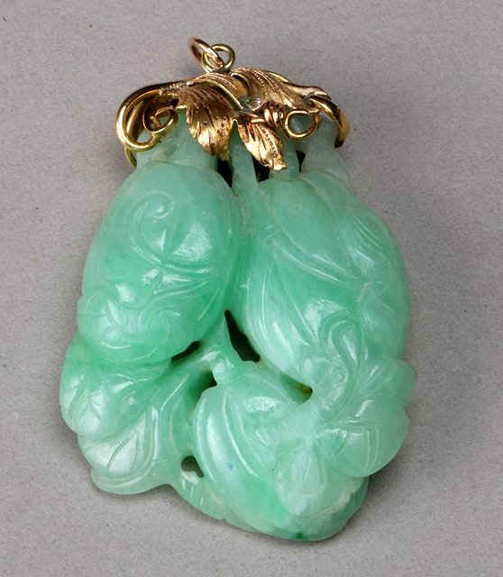 Appraisal: A GOLD MOUNTED JADE PENDANT carved in the form of