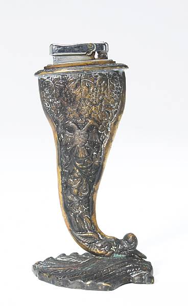 Appraisal: A bronze lighter carved grapevine design on seashell base in