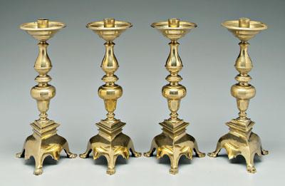 Appraisal: Set of four cast brass candlesticks baluster shafts above tripod