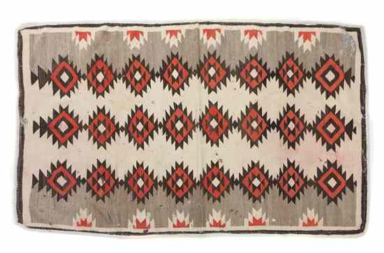 Appraisal: A Navajo Rug having repeating geometric decoration within a double