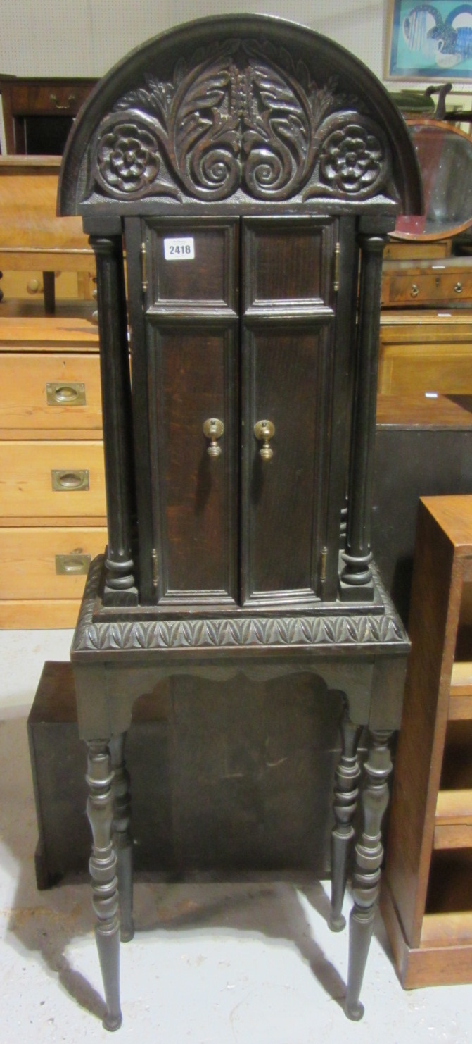 Appraisal: A th century oak tall pier cabinet with carved arch