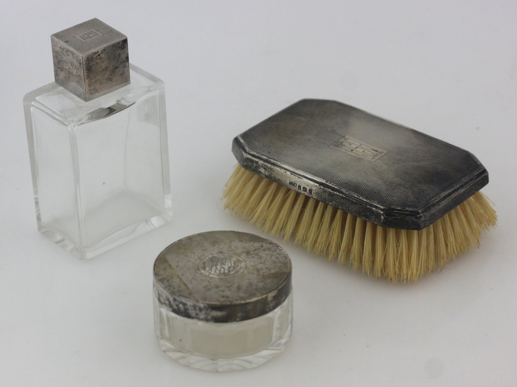 Appraisal: A gentleman's silver-backed hairbrush Asprey Co London and two matching