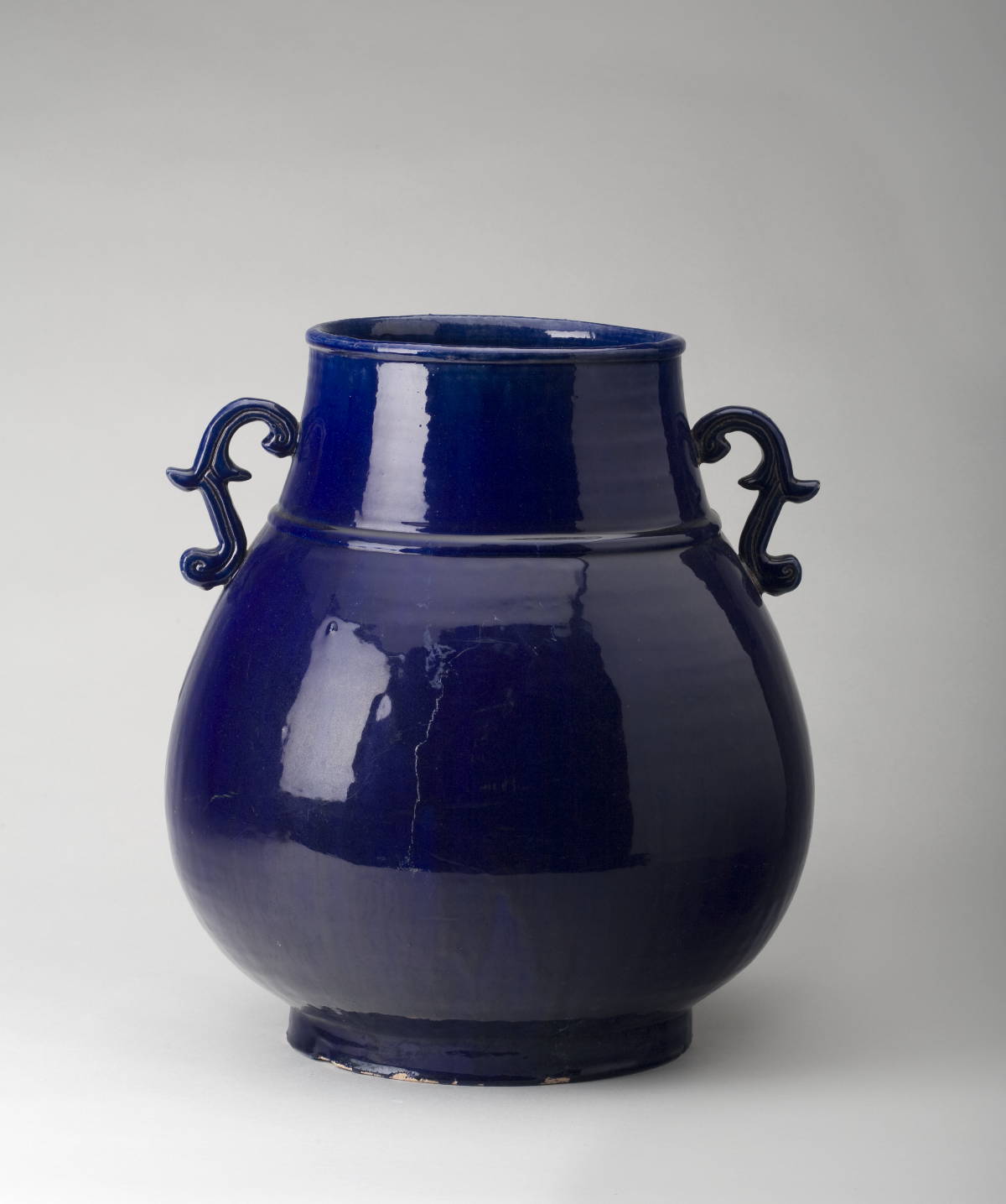 Appraisal: CHINESE PORCELAIN DEEP BLUE-GLAZED BULBOUS VASE WITH SCROLL HANDLES Height