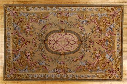 Appraisal: SAVONNERIE-STYLE CARPET The oval husk wreath central medallion anchored to