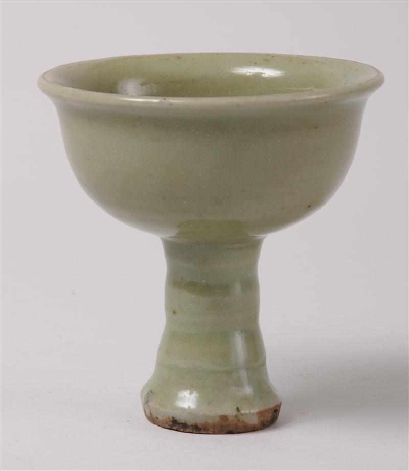 Appraisal: CHINESE CELADON-GLAZED STEM CUP MING The hemispherical bowl with everted