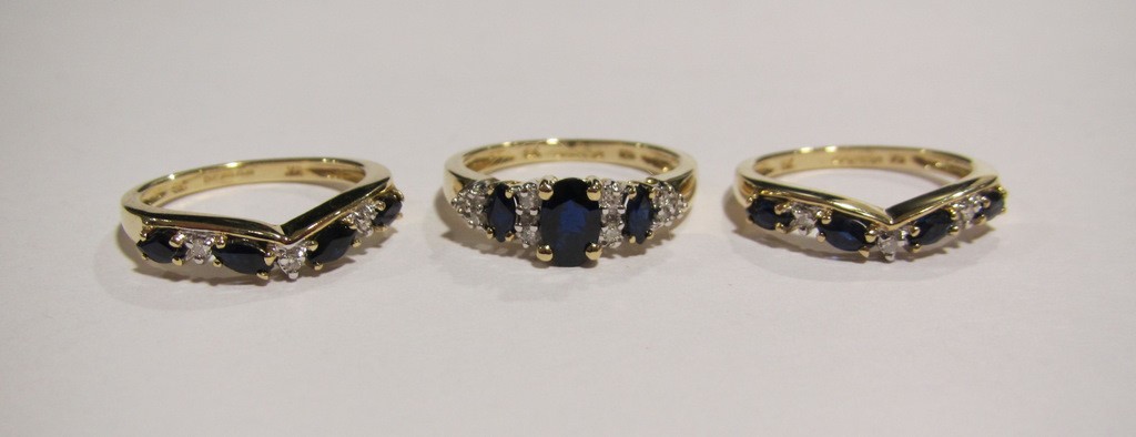 Appraisal: Nine carat gold sapphire and diamond trilogy ring with a