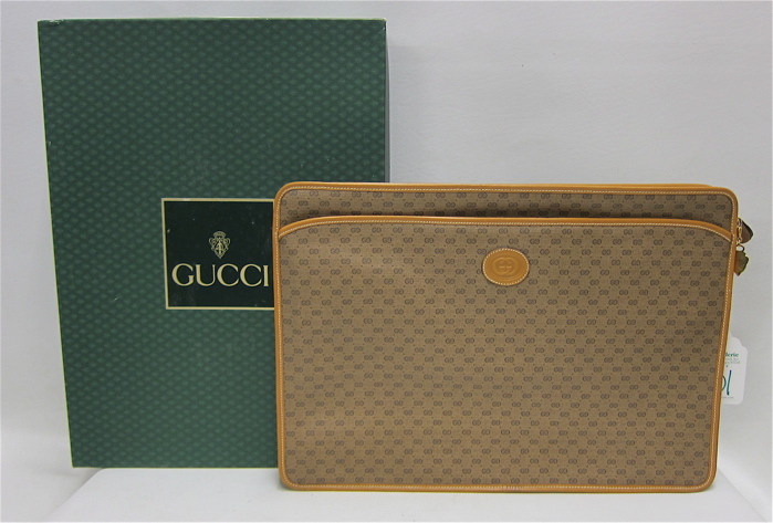 Appraisal: GUCCI CANVAS BRIEFCASE embossed with the Gucci logo leather interior