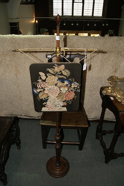 Appraisal: A VICTORIAN MAHOGANY POLE SCREEN with wool work panel on