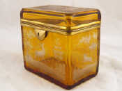 Appraisal: A continental amber glass lockable tea caddy wheel engraved decoration