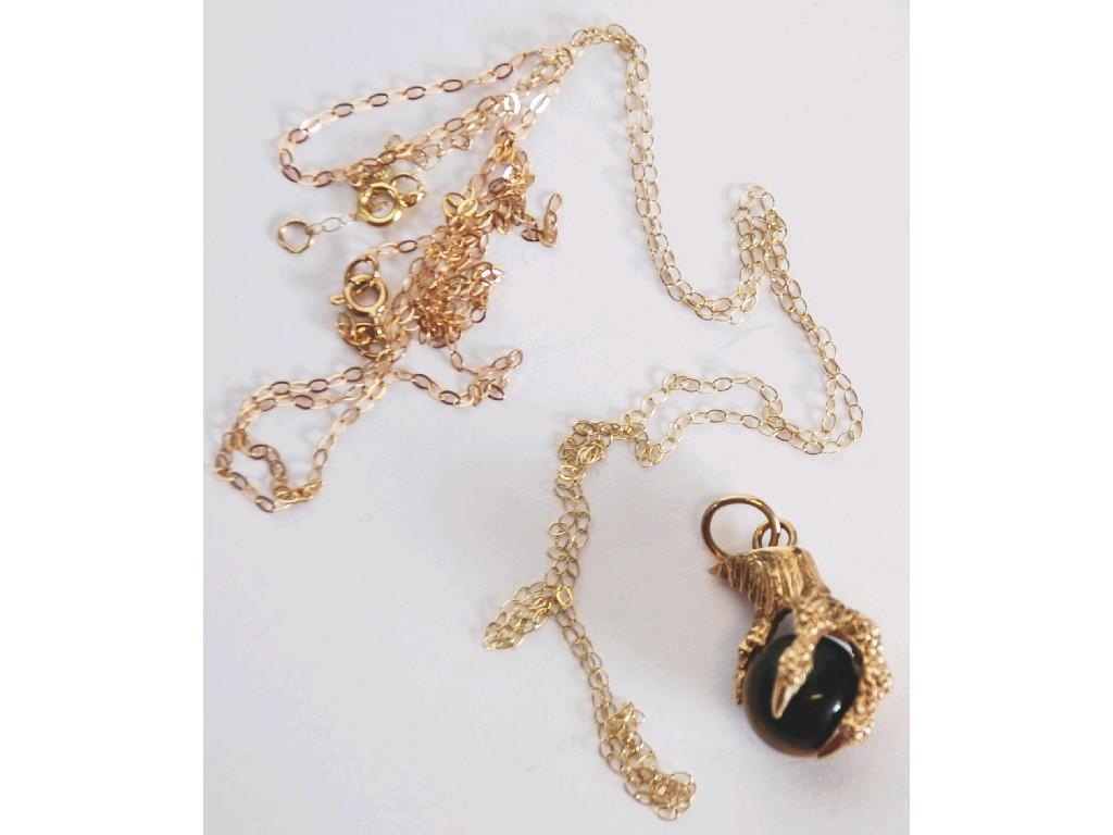 Appraisal: CT GOLD CLAW PATTERN PENDANT hold a tiger's eye stone