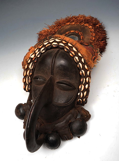 Appraisal: AN AFRICAN DAN MASK with applied cowrie shell decoration and