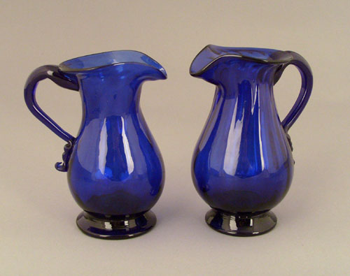 Appraisal: Two cobalt glass creamers ca with vertical ribs h Provenance