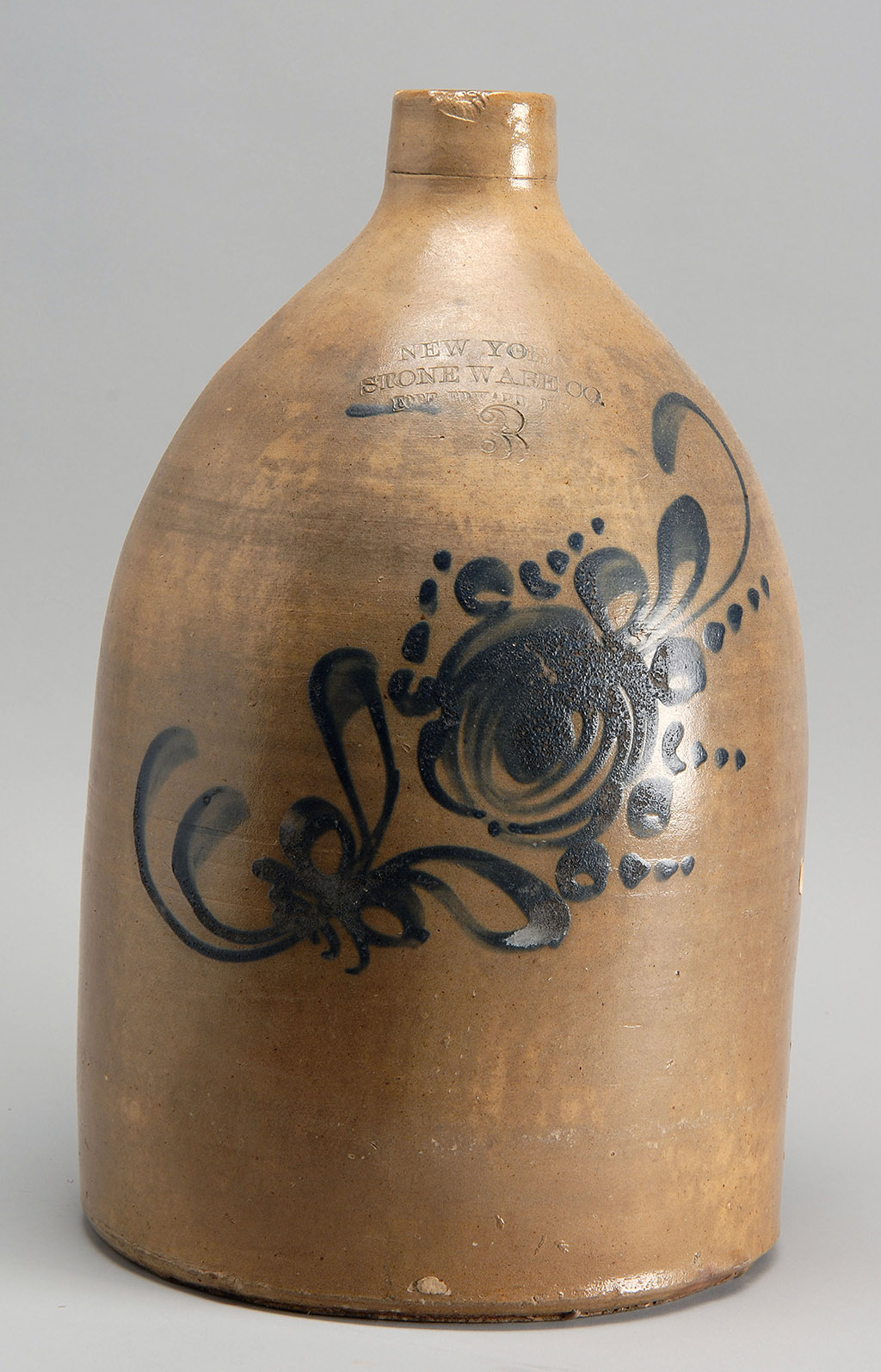 Appraisal: TH CENTURY AMERICAN STONEWARE JUG with cobalt blue foliate decoration