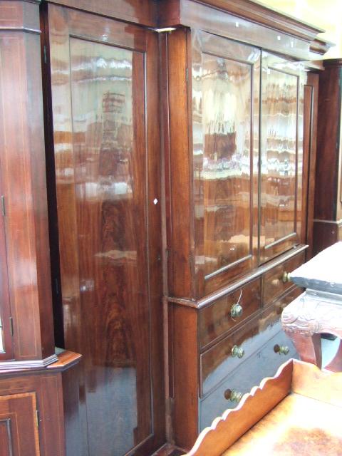 Appraisal: A early th century mahogany triple section breakfront wardrobe the