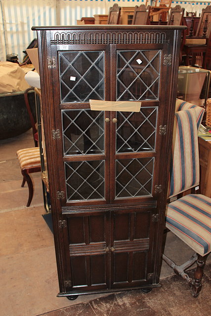 Appraisal: A 'S OAK CORNER CABINET the two lead glazed doors