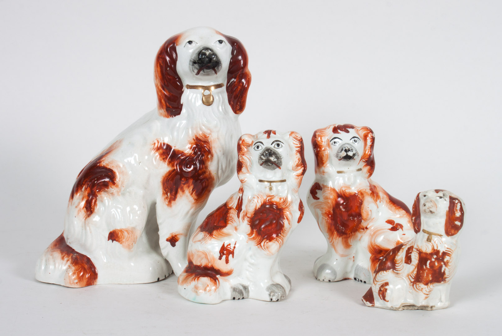 Appraisal: Four Staffordshire earthenware spaniels including pair and two other spaniels