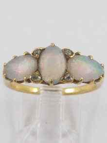 Appraisal: A yellow metal test ct gold three stone opal ring