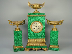 Appraisal: A Continental Empire style composite malachite clock garniture with ormolu