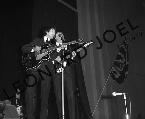 Appraisal: GEORGE HARRISON AND JOHN LENNON PERFORMING ON STAGE