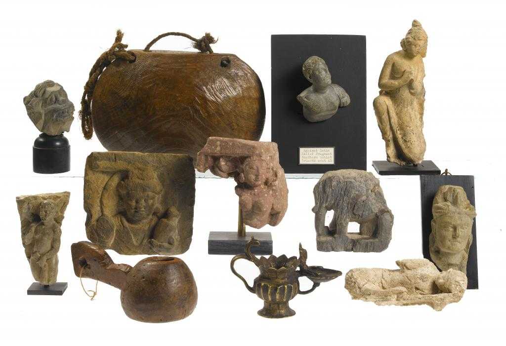 Appraisal: A GROUP OF GANDHARAN SCULPTED SCHIST STUCCO AND RED SANDSTONE