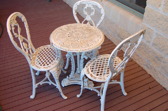 Appraisal: A VICTORIAN WHITE PAINTED CAST IRON GARDEN TABLE AND THREE