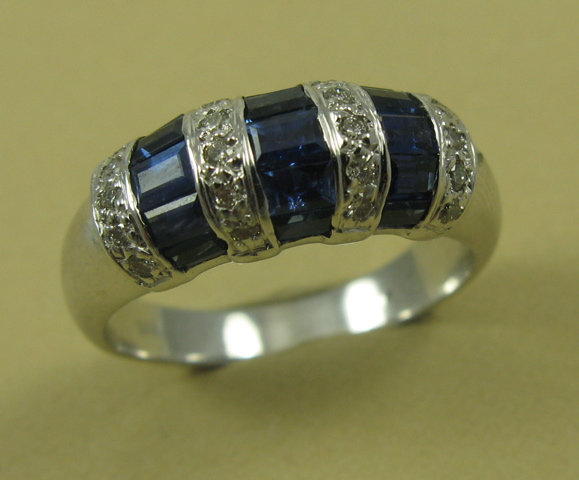 Appraisal: SAPPHIRE DIAMOND AND FOURTEEN KARAT GOLD RING set with tapered