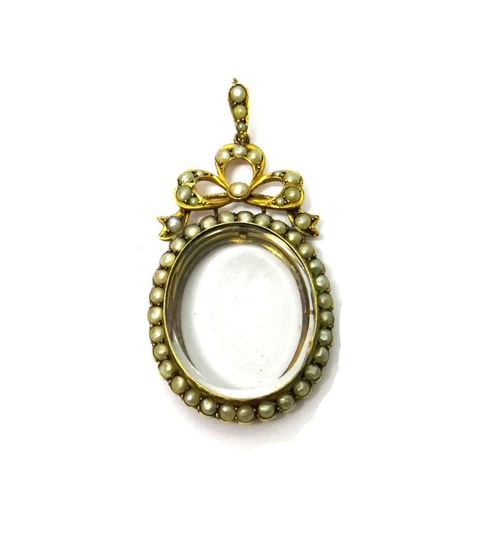 Appraisal: A gold and half pearl set pendant locket of oval