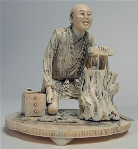 Appraisal: A Japanese carved ivory okimono of a carpenter Meiji period