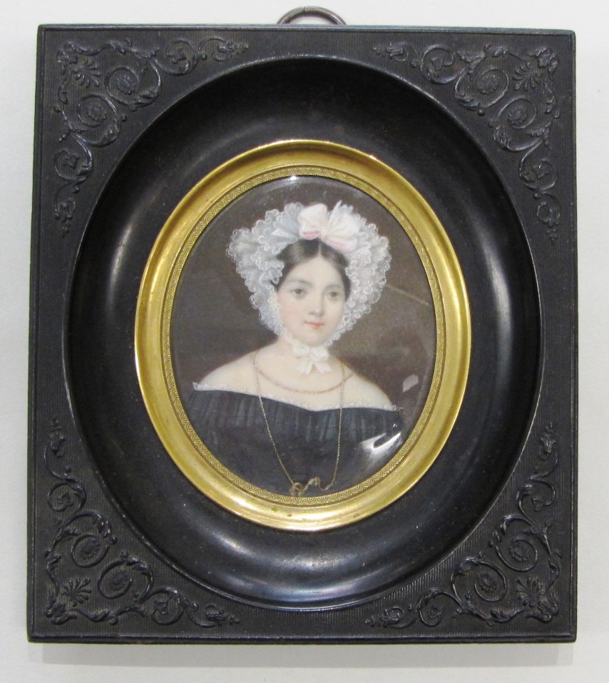 Appraisal: An oval portrait miniature of a lady with dark brown