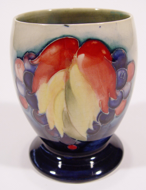 Appraisal: Moorcroft goblet shaped pottery vase hand painted and tubelined with