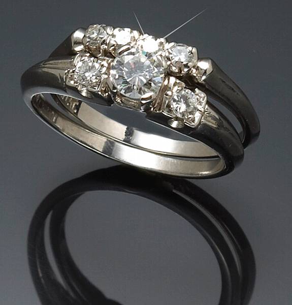 Appraisal: A diamond and platinum wedding set estimated total diamond weight