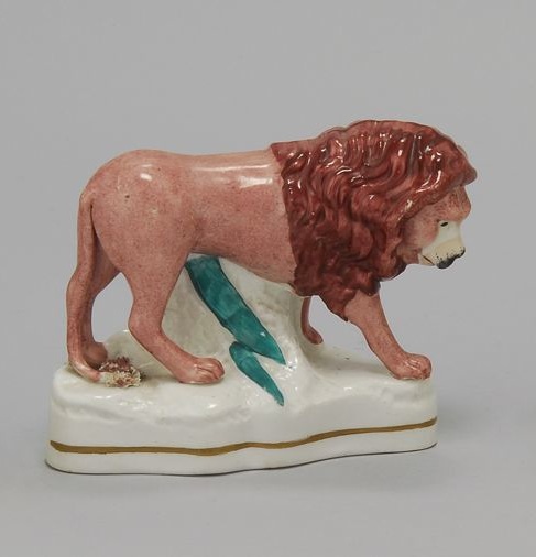 Appraisal: STAFFORDSHIRE FIGURE OF A LION - In light red with