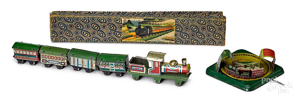 Appraisal: Two lithograph tin train penny toys Two lithograph tin train