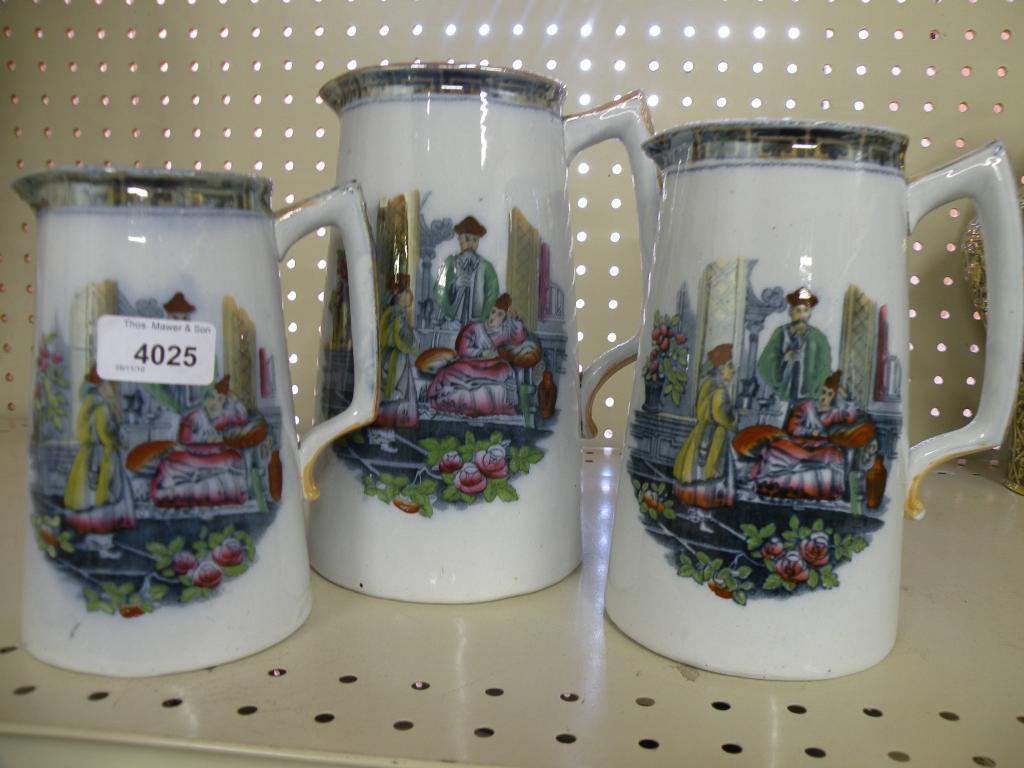 Appraisal: A set of three graduated jugs each printed with oriental