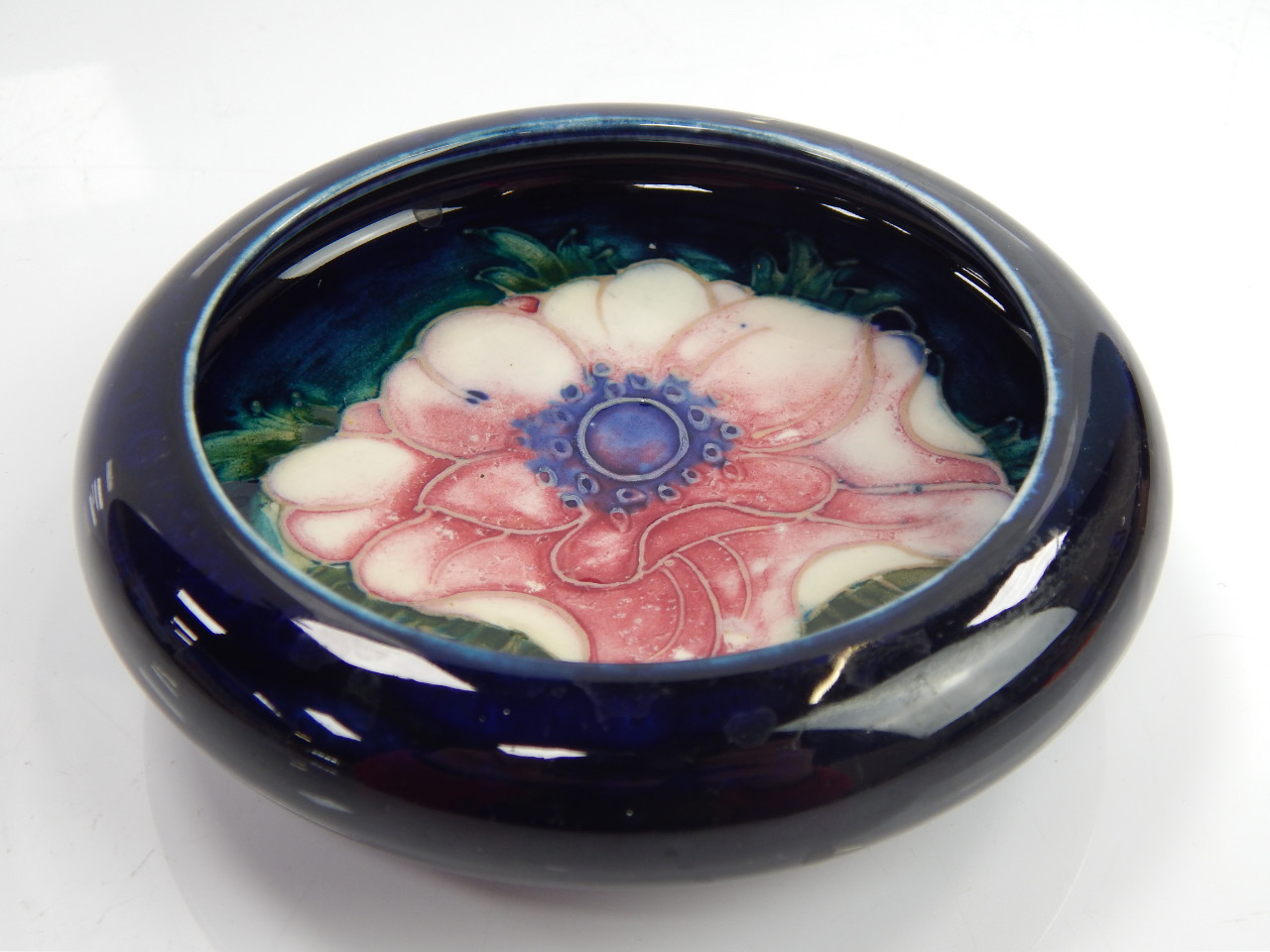 Appraisal: A small Moorcroft shallow bowl with inverted border and decorated