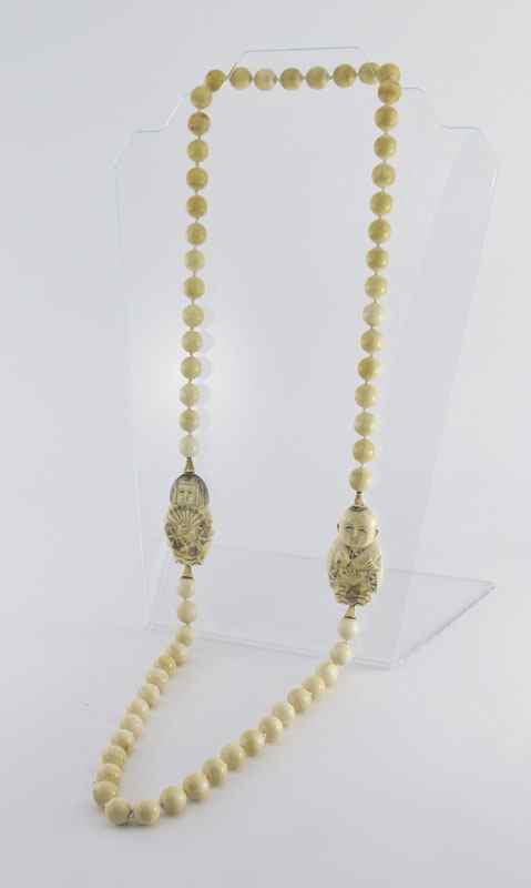 Appraisal: CARVED IVORY NECKLACE '' strand necklace of mm ivory beads