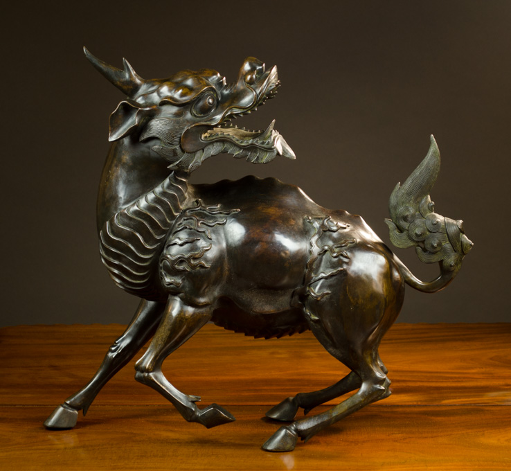 Appraisal: CHINESE QING DYNASTY PATINATED BRONZE QILIN a mythical hoofed chimerical