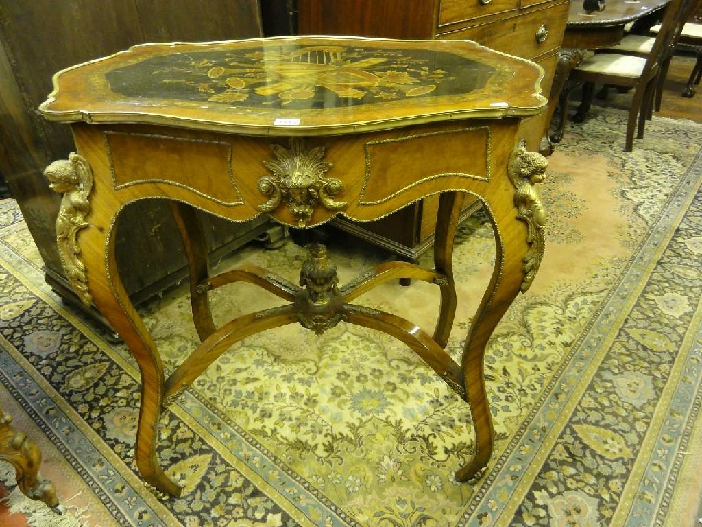 Appraisal: A continental walnut centre table with shaped outline inlaid musical