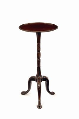 Appraisal: A mahogany torchere the dished circular top with a ribbed