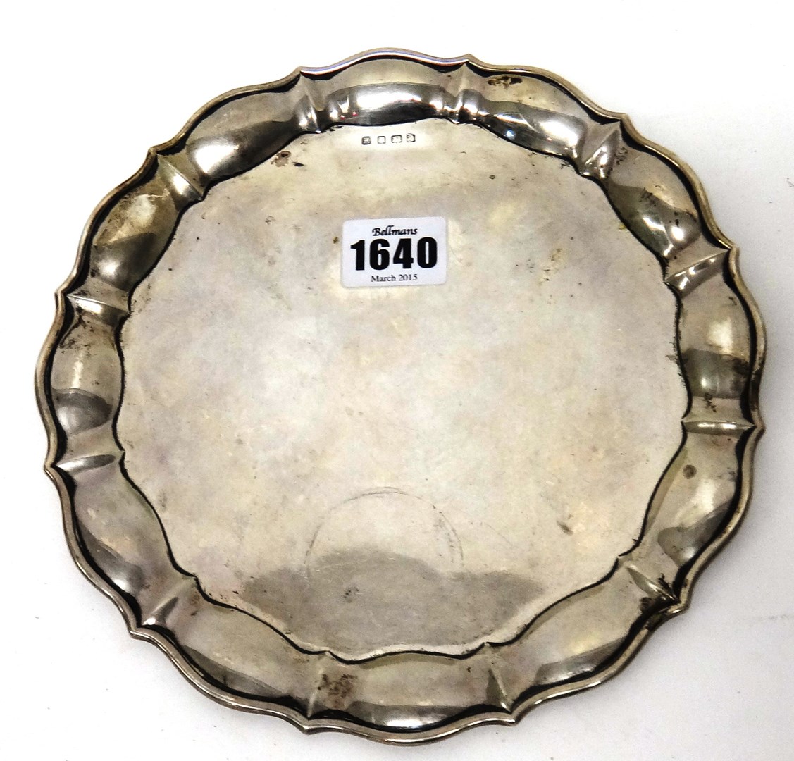 Appraisal: A silver shaped circular waiter with a Chippendale style piecrust