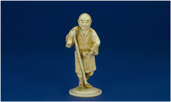 Appraisal: Japanese Ivory Figure Circa Man with staff in one hand