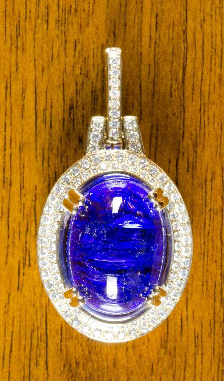 Appraisal: TANZANITE DIAMOND AND FOURTEEN KARAT GOLD PENDANT with two rows