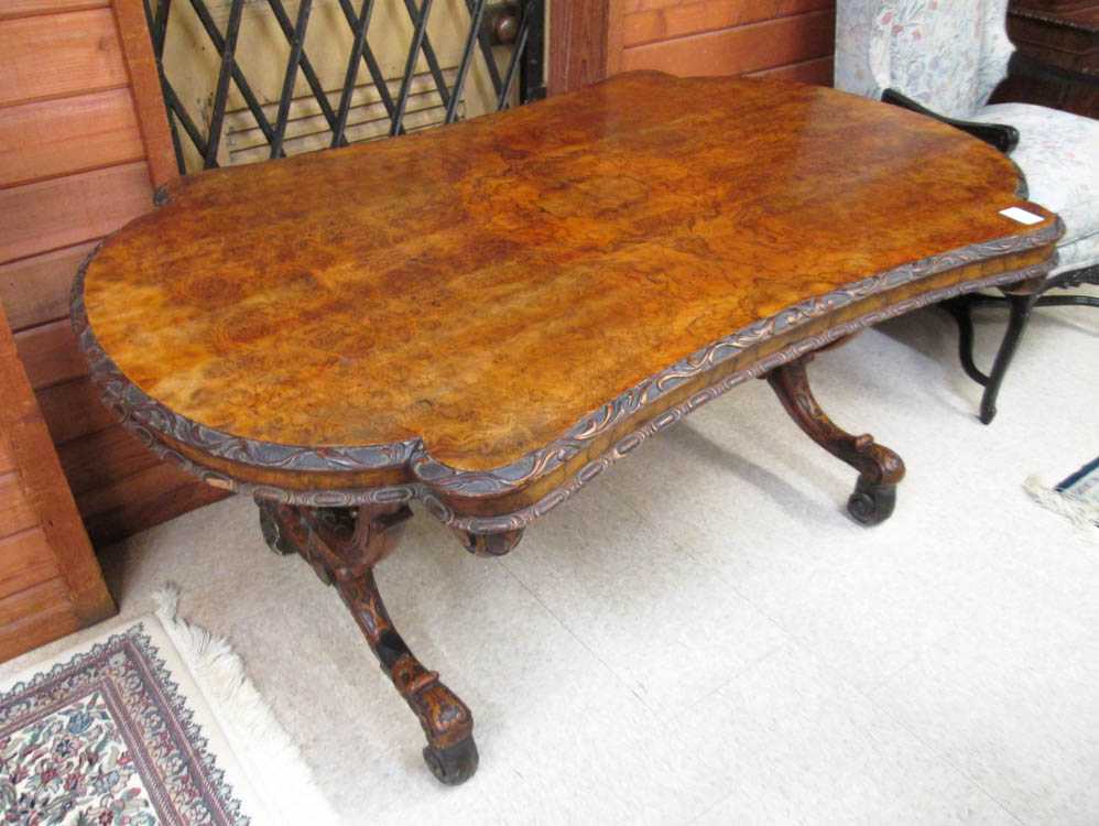 Appraisal: A VICTORIAN CARVED BURL WALNUT CENTER TABLE English th century