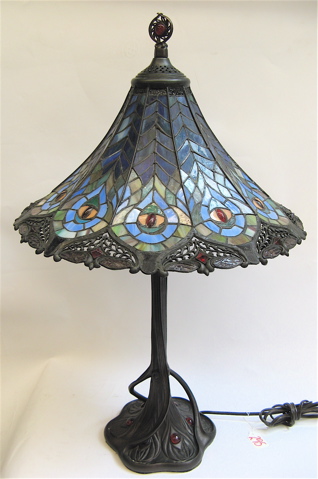 Appraisal: A PEACOCK SHADE ON TREE TRUNK BASE The table lamp