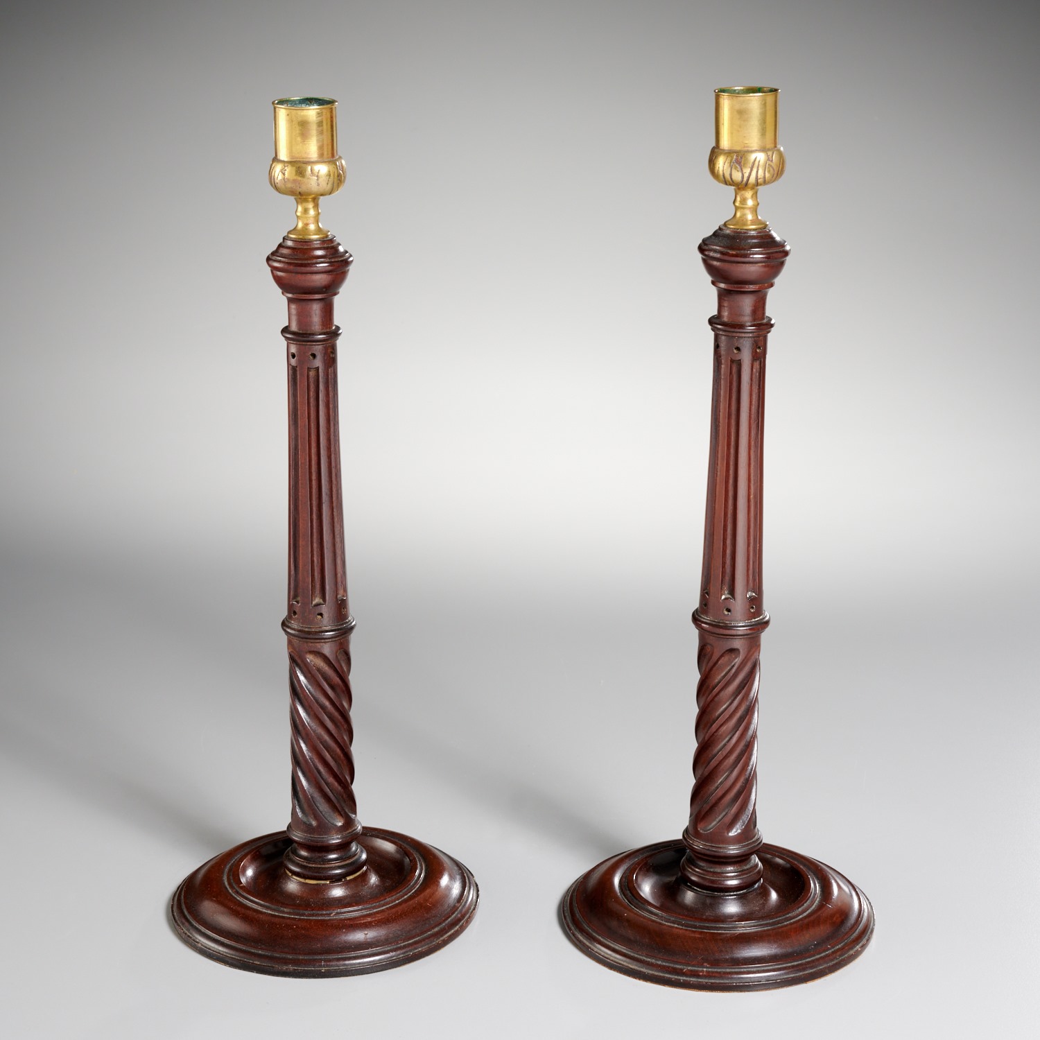 Appraisal: PAIR ENGLISH TURNED MAHOGANY CANDLESTICKS th c fluted and spiral