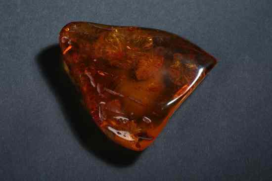 Appraisal: UNMOUNTED PIECE POLISHED BALTIC AMBER With foliate inclusions - in