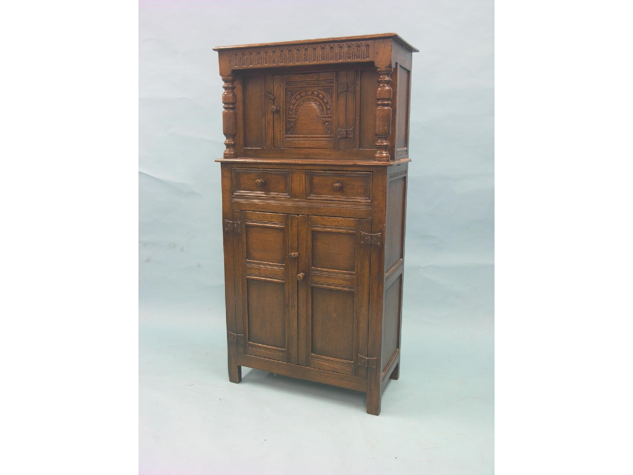 Appraisal: A small th century-style oak court cupboard carved cupboard door