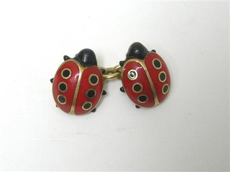 Appraisal: A pair of enamelled novelty cufflinks each terminal designed as